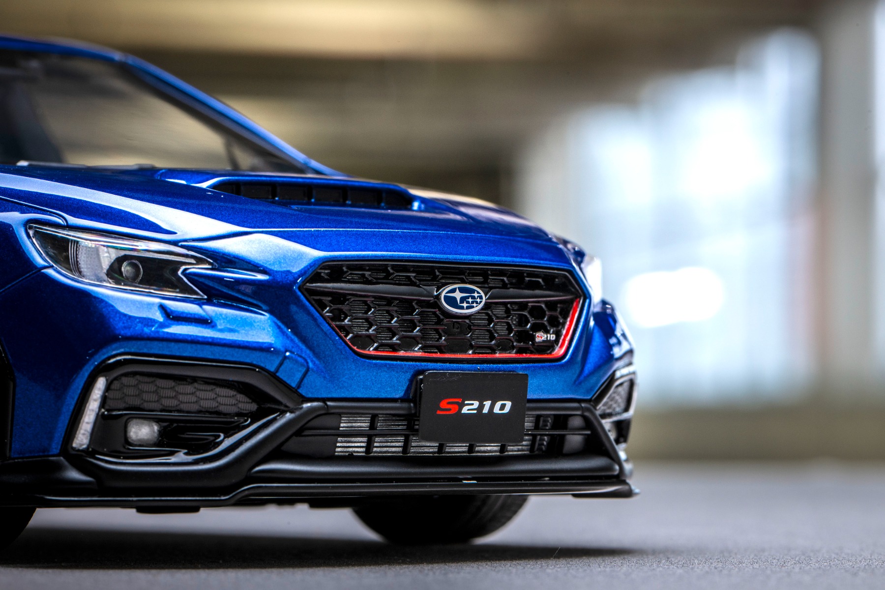 フロントマスクでも標準車との差別化が図られ、グリルはブラック塗装＋チェリーレッドストライプ仕様に変更。さらにSTIフロントアンダースポイラーを追加し、LEDアクセサリーライナーも装着されます。