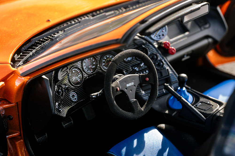 インテリアは部分的にブルーのスエードで張り替え。シフトライト付きの大径オートメーター（タコメーター）もダッシュボードに設置されています。安全性とともにボディ剛性を高めるロールケージも存在感を放っています。
